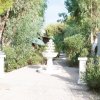 Una fontana bianca tra alberi e sentieri pavimentati.