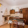 Cucina rustica con tavolo da pranzo e camino in pietra.